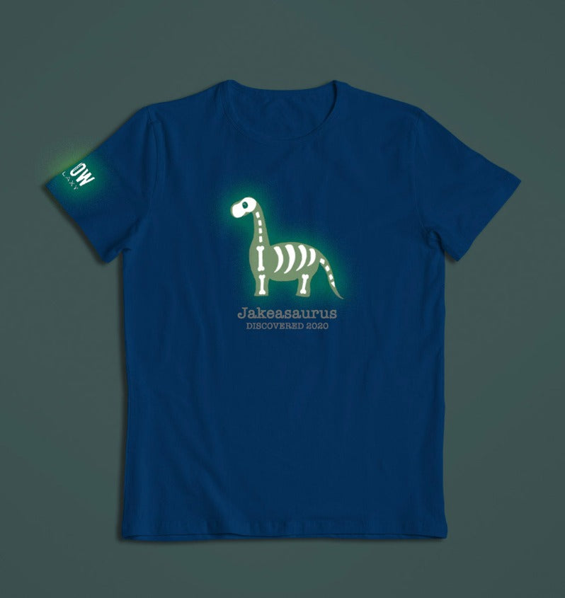 a personalised dinosaur t-shirt that glows in the dark in blue