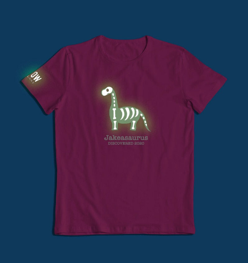 a personalised dinosaur t-shirt that glows in the dark in pink