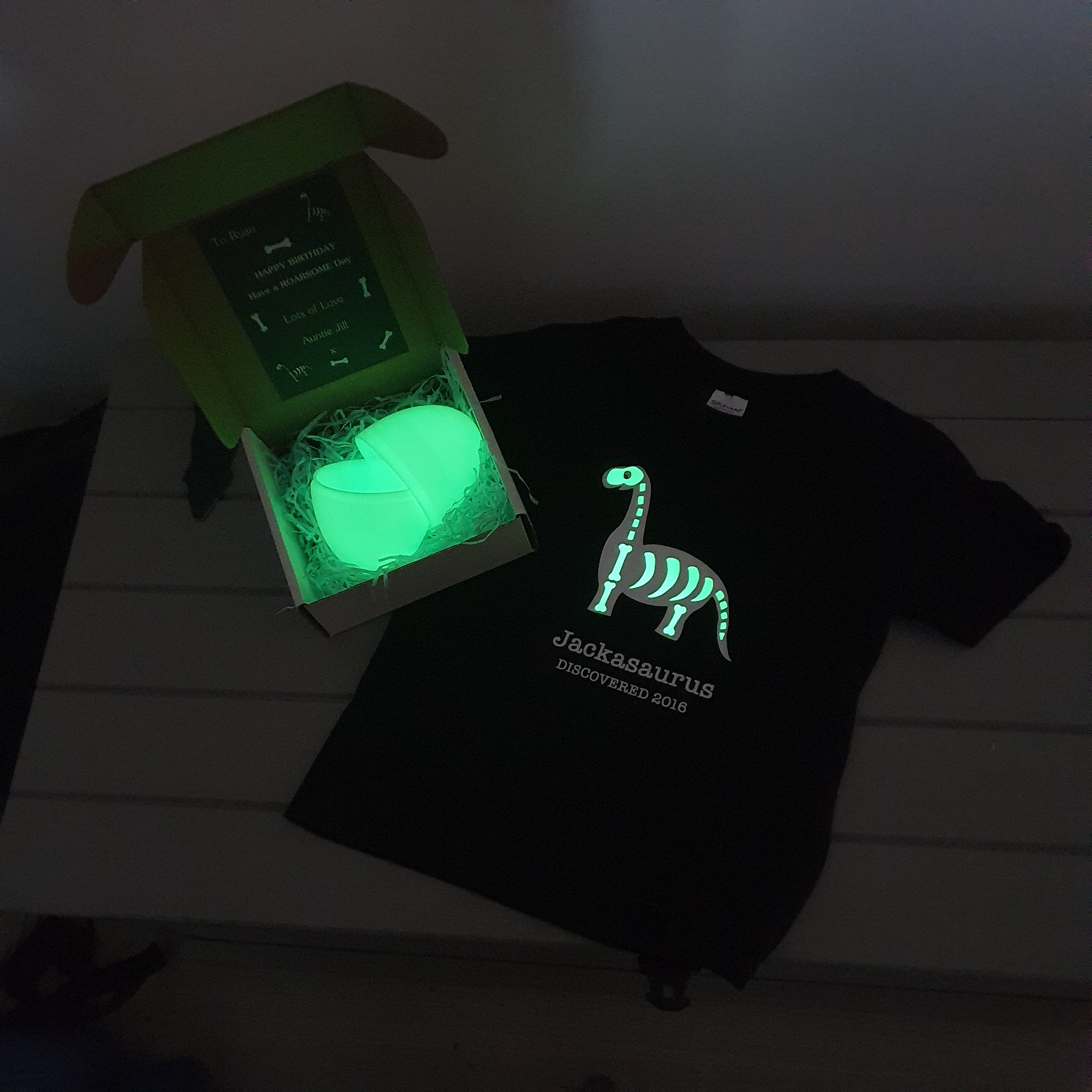 glow in the dark dinosaur t-shirt in a glowing egg
