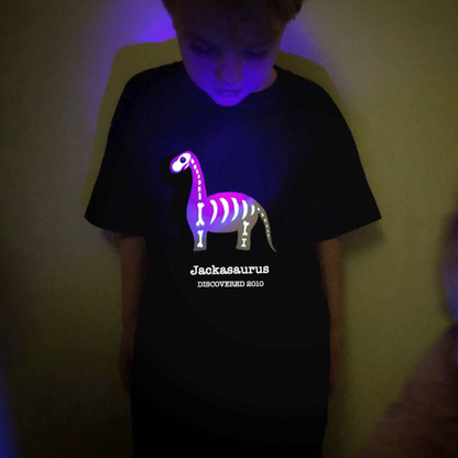 a boy in a glow in the dark dinosaur t-shirt